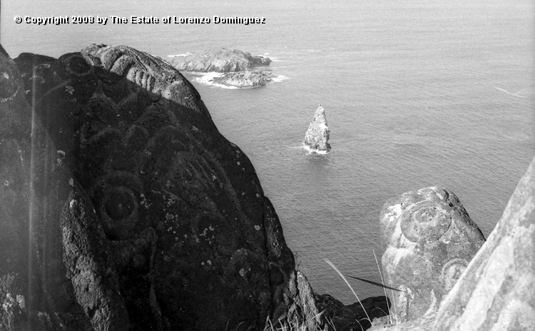 ORO_075.jpg - Easter Island. 1960. Orongo. Rocks with petroglypha and the three small islands or motu in the background.